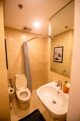 a bathroom with a toilet and a sink at Antel Spa & Serenity Suites in Manila