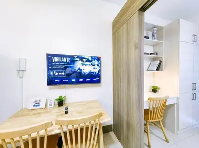 a dining room with a wooden table and chairs at 1BR Condotel with Balcony at FAME Residences #FM15 in Manila