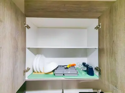 a cupboard with a stove in a kitchen at 1BR Condotel with Balcony at FAME Residences #FM16 in Manila