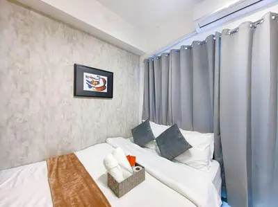a hotel room with two beds and a window at 1BR Condotel with Balcony at FAME Residences #FM16 in Manila