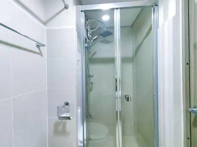 a shower with a glass door in a bathroom at 1BR Condotel with Balcony at FAME Residences #FM16 in Manila
