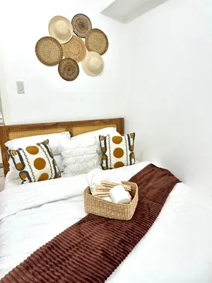 a bedroom with a bed with a basket on it at Azure Luxury Suite in Manila
