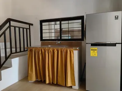 a kitchen with a sink and a refrigerator at Green Glory Staycation in Amadeo in Cavite