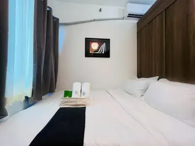 a bedroom with a bed with two towels on it at 1BR Condotel with Balcony at FAME Residences #FM19 in Manila