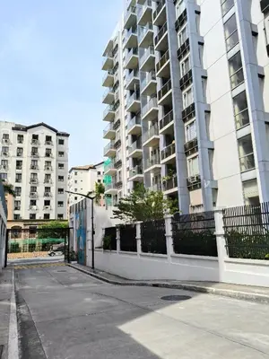 an empty street in front of a tall building at LDN Secret Crib - Two Palm Tree Newport City in Manila