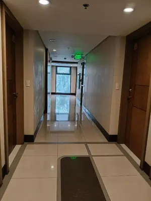 an empty hallway with green lights in a building at LDN Secret Crib - Two Palm Tree Newport City in Manila