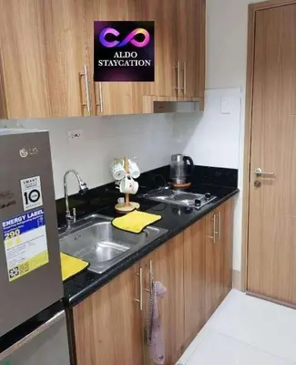 a kitchen with a sink and a counter top at Mall of Asia Pasay Shore 3 residences tower 2 in Manila