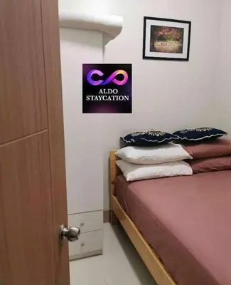 a bedroom with a bed and a sign on the wall at Mall of Asia Pasay Shore 3 residences tower 2 in Manila
