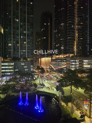 a view of a city at night with a fountain at BGC Staycation: 1BR Condo Uptown Area #ournw12d in Manila