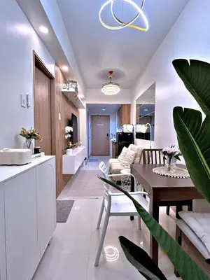 a living room with a table and a dining room at The 3rd Staycation Near MOA, Airport, with FREE WIFI, Netflix in Manila