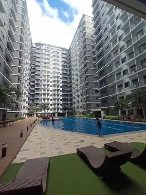 a swimming pool in the middle of two large buildings at The 3rd Staycation Near MOA, Airport, with FREE WIFI, Netflix in Manila