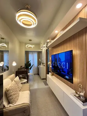 a living room with a large tv on a wall at The 3rd Staycation Near MOA, Airport, with FREE WIFI, Netflix in Manila