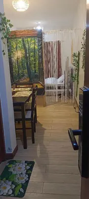 a dining room with a table and chairs and a window at Condotel Near NAIA - massage chair footspa, dance revo, small pet allowed in Manila