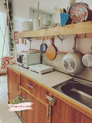 a kitchen with a sink and a microwave at El Nissi Staycation, THE COLOR CABIN, Enchanted Kingdom in Santa Rosa