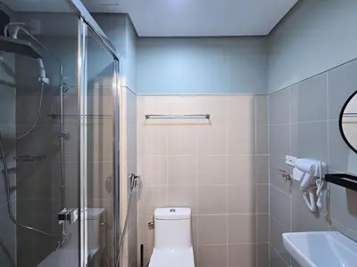 a bathroom with a shower and a toilet and a sink at 1BR Condotel with Balcony at FAME Residences #FM46 in Manila