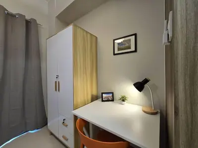 a white desk with a lamp and a white cabinet at 1BR Condotel with Balcony at FAME Residences #FM45 in Manila