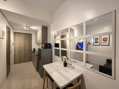 a small kitchen with a table in a room at 1BR Condotel with Balcony at FAME Residences #FM49 in Manila