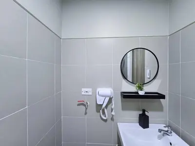a white bathroom with a sink and a mirror at 1BR Condotel with Balcony at FAME Residences #FM50 in Manila