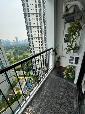 a balcony with a view of a city at Minimalist Luxury Spacious 1 Bedroom in Burgos Circle in Manila