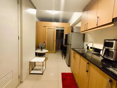a small kitchen with a sink and a refrigerator at Angelica Staycation at Mall of Asia Shell Residence in Manila