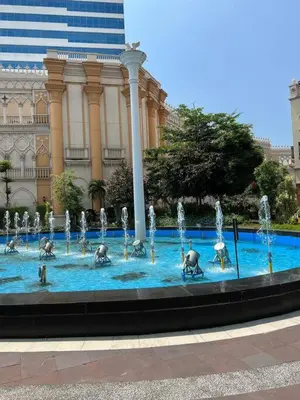 a fountain in front of a building with elephants in the water at Studio at viceroy 4 Taguig in Manila