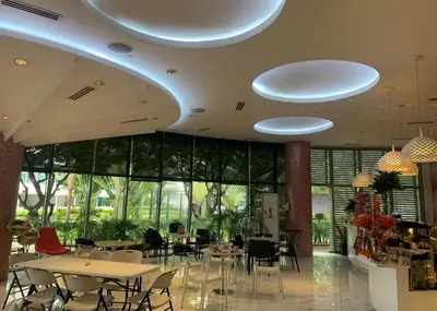 a restaurant with tables and chairs in a building at Budget Suite Paranaque in Manila