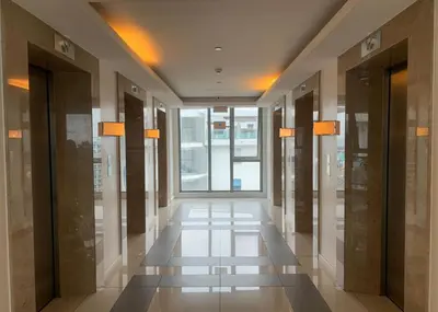 a hallway of a building with doors and windows at Budget Suite Paranaque in Manila