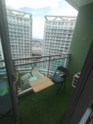 a room with a chair and a balcony with a view at Azure - Stellar Property in Manila