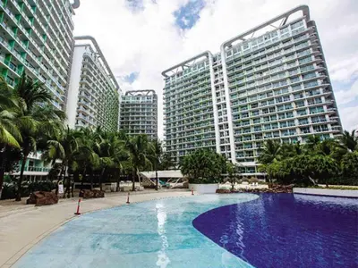 a large swimming pool in front of two tall buildings at High-end 2BR Condo Boracay Tower - Azure Residences near Manila Airport in Manila