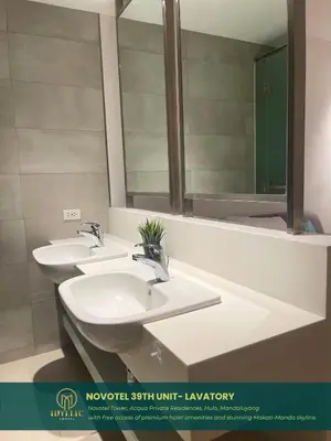 a bathroom with two sinks and a large mirror at Novotel Twin Bed at Mandaluyong Near Makati FREE pool in Manila
