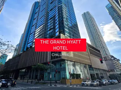 a large building with a sign that reads the grand hyatt hotel at Premium BGC 1BR Condo Near Grand Hyatt #oursw9d1 in Manila