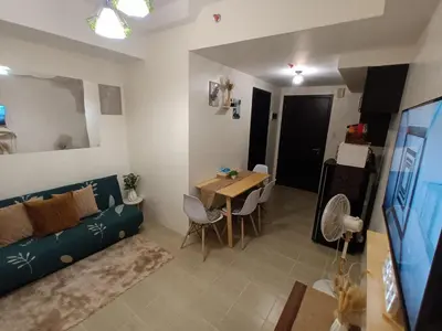 a living room with a couch and a table at Chill Spot Staycation in Pasig in Manila