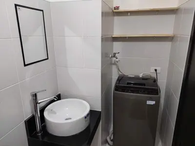 a small bathroom with a toilet and a mirror at Chill Spot Staycation in Pasig in Manila