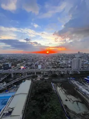 a view of a city with the sunset in the background at Spacious 2BR Condo San Lorenzo Place 4KM Airport in Manila