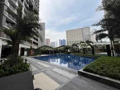 a swimming pool in the middle of a city at West Bricks in Manila