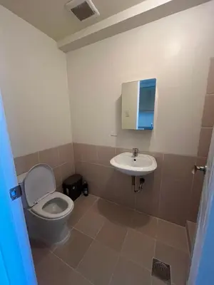 a bathroom with a toilet and a sink at West Bricks in Manila