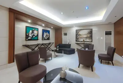 a waiting room with chairs and a table at SMDC Breeze Residences by RedDoorz in Manila