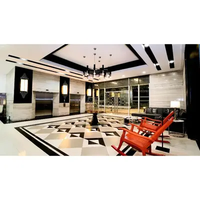 a living room with a large lobby with red chairs at Summit Hotel Magnolia in Manila