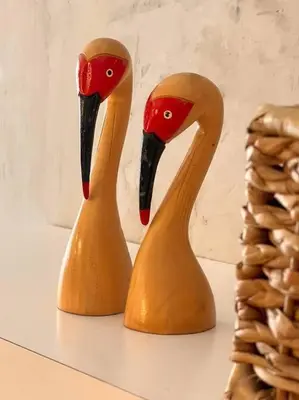 two wooden sculptures of swans sitting on a shelf at Modern minimalist house in the heart of Antipolo in Antipolo