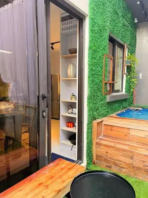 a room with a green wall with a tub at Modern minimalist house in the heart of Antipolo in Antipolo