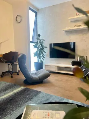 a living room with a tv and a couch and a chair at Modern minimalist house in the heart of Antipolo in Antipolo
