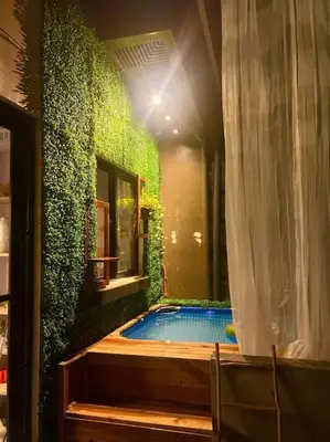 a house with a swimming pool with a green wall at Modern minimalist house in the heart of Antipolo in Antipolo