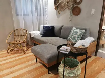 a living room with a couch and a table at Tropical hideaway near Antipolo Cathedral in Antipolo