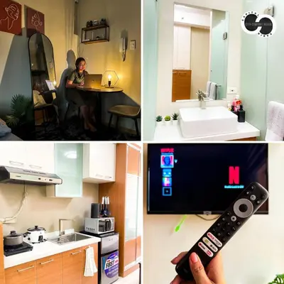 a person holding a remote control in a kitchen at Sunshine 100 Stylish Condo by The Capital Cabin in Manila