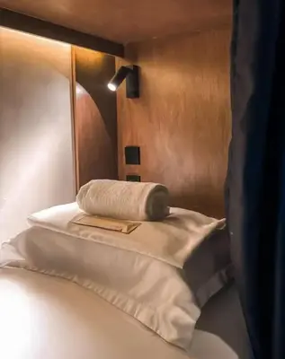 a bed with a towel sitting on top of it at Yamato Hostel in Manila