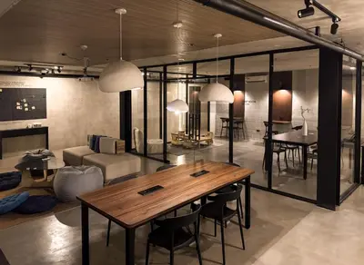 a living room with a wooden table and chairs at Yamato Hostel in Manila