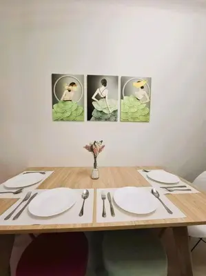 a wooden table with plates and utensils on it at Comfy Condo Near NAIA Airport in Manila