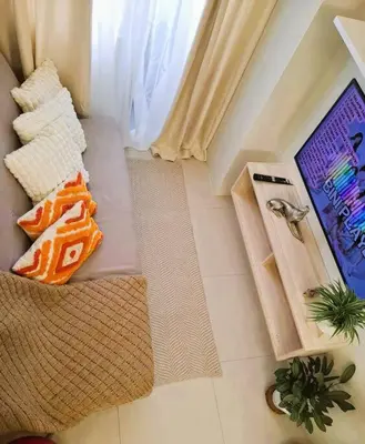 an overhead view of a living room with two pillows at Comfy Condo Near NAIA Airport in Manila
