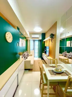 a kitchen and living room with a clock on the wall at Cozy and aesthetic unit near MOA Airport and IKEA in Manila
