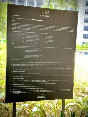 a sign in a park with a bunch of text on it at Cozy and aesthetic unit near MOA Airport and IKEA in Manila